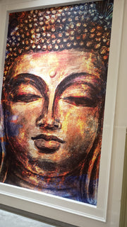 Framed artwork of a stylized Buddha face with warm colors.